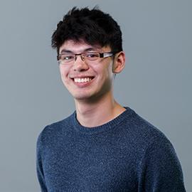 A man smiling to the camera.